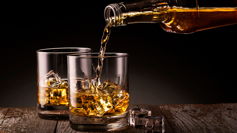 Pouring whiskey on ice