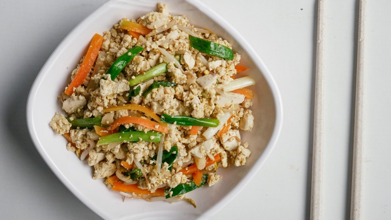 tofu scrambled on dish with chopsticks