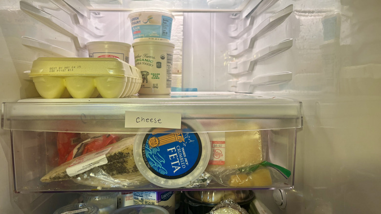 Fridge drawer filled with cheese