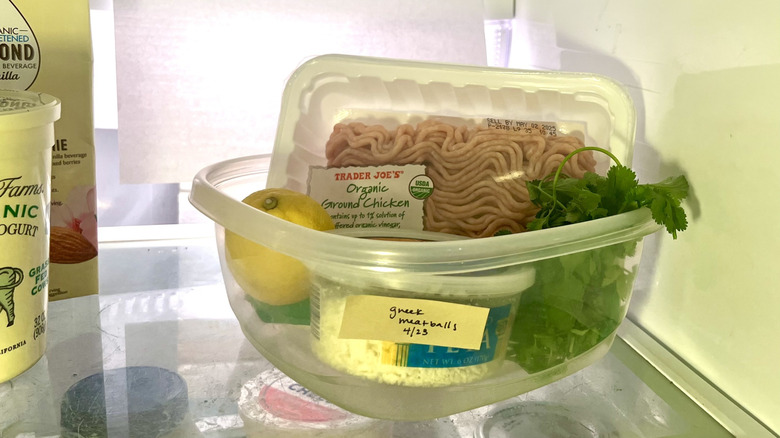 Plastic container filled with ingredients for Greek meatballs