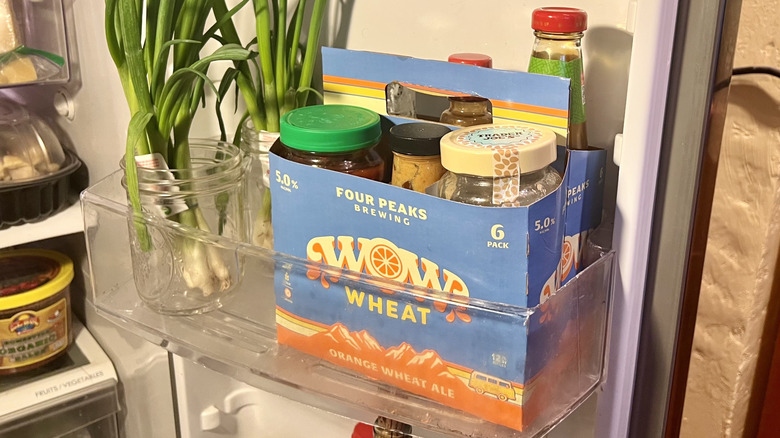 6-pack box filled with various condiments sitting in fridge door