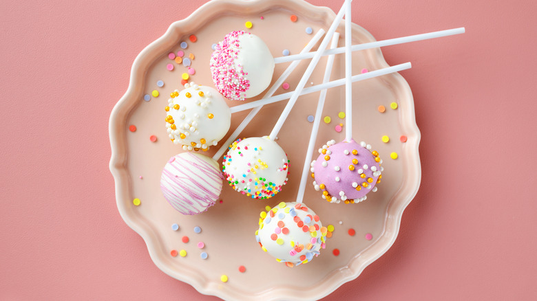 Six cake pops sit on a plate