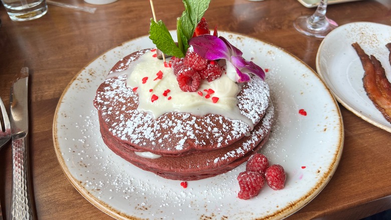 Red velvet pancakes are topped with frosting