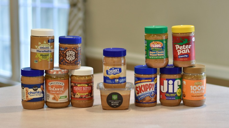 A collection of peanut butter jars on a counter