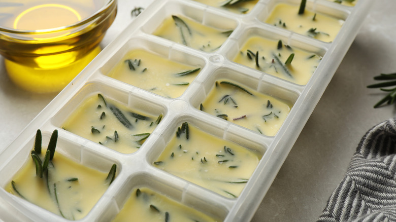Ice cube tray filled with herbed olive oil mixture
