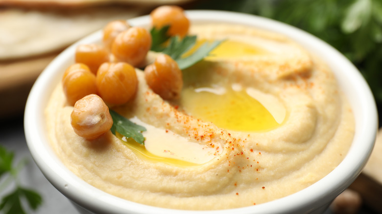A bowl of hummus garnished with whole chickpeas
