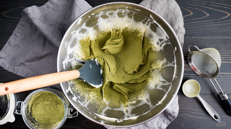 matcha dusting into whipped cream