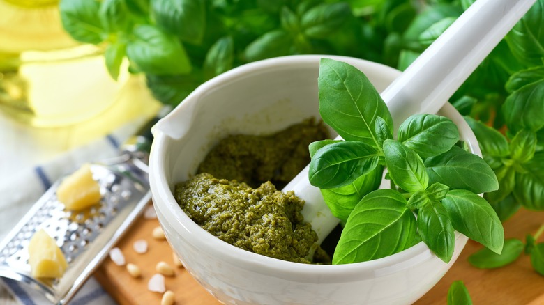 Homemade basil in white mortar and pestle