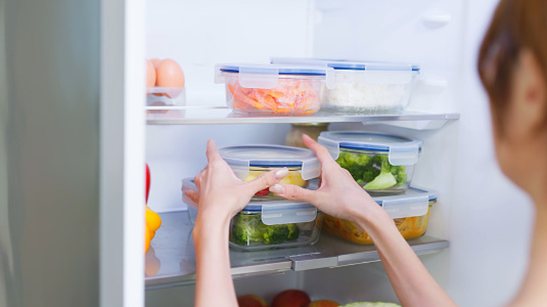 Person putting food away in a kitchen