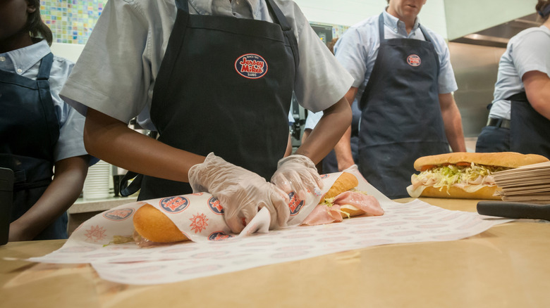 An employee prepares a sub at Jersey Mike's