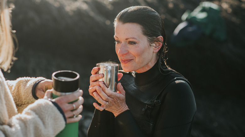 Woman drinking hot beverage from Thermos