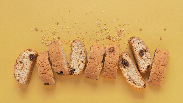 Biscotti and crumbs on a yellow background