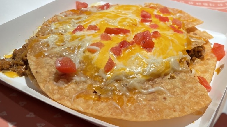 A Mexican Pizza topped with nacho cheese