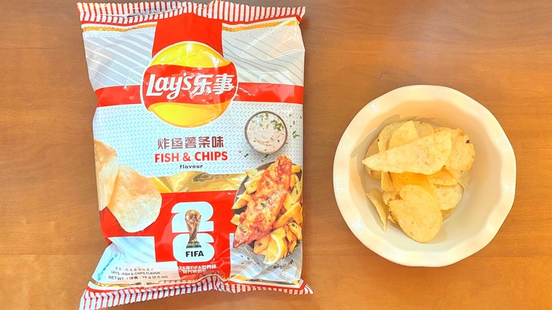 white and red FIFA Fish & Chips chip bag next to a white bowl of chips