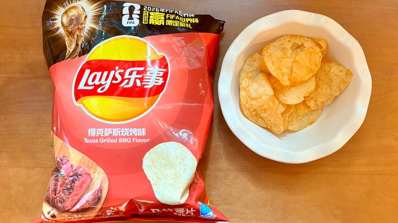 red Texas BBQ chip bag next to a white bowl of chips