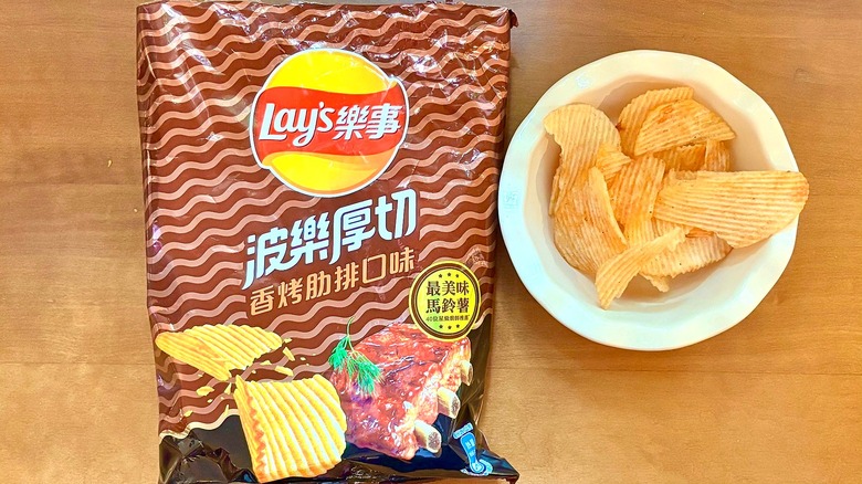 brown, wavy-patterned Pole Roasted Pork chip bag next to a white bowl of chips