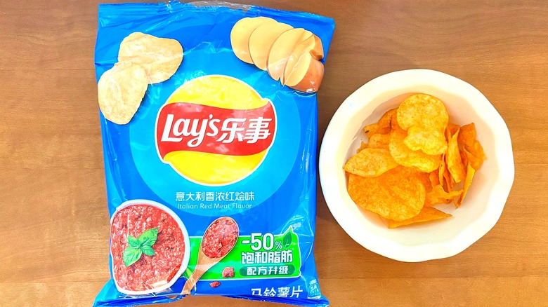 bright blue Italian Red Meat chip bag next to a white bowl of chips
