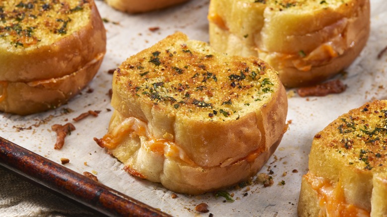 Mini baked grilled cheese sandwiches, also known as cheese dreams