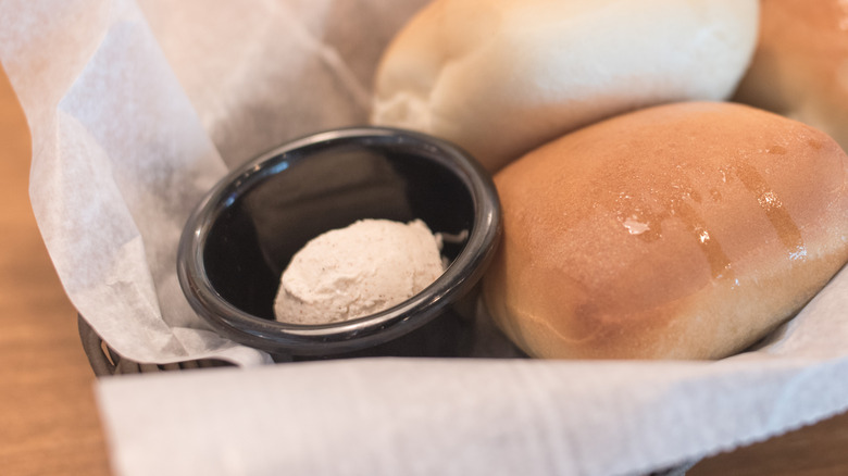 A basket of rolls with honey cinnamon butter