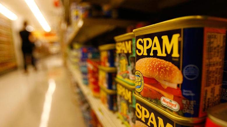 Cans of Spam on grocery shelf