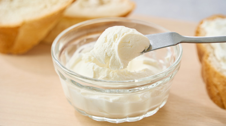 Bowl of cream cheese with bread