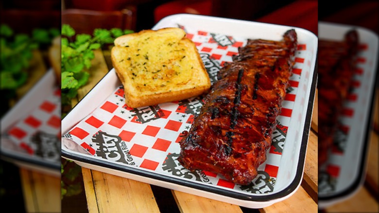 Ribs and garlic bread on a Rib City tray