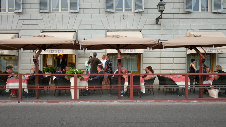 People dining outside in Florence at Harry's Bar