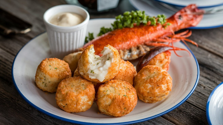 A plate of hush puppies with seafood