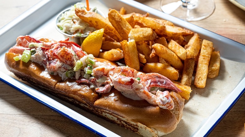 A lobster roll with thick-cut fries and coleslaw at Legal Sea Foods