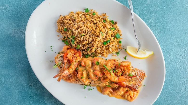 A plate of Atlantic Salmon Alexander with dirty rice at Pappadeux Seafood Kitchen