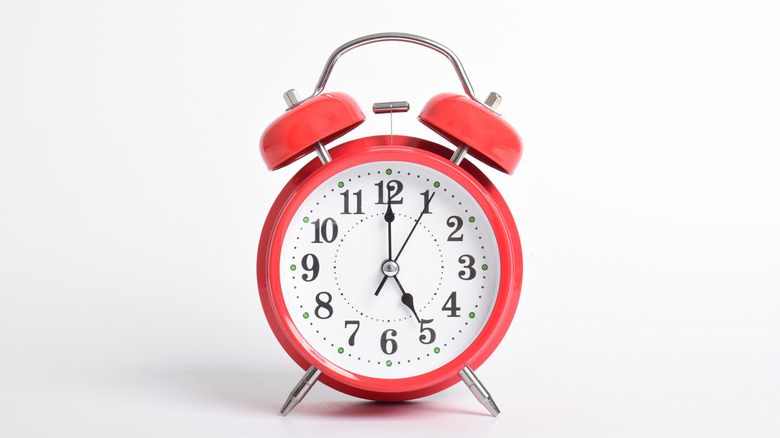 red alarm clock on white background