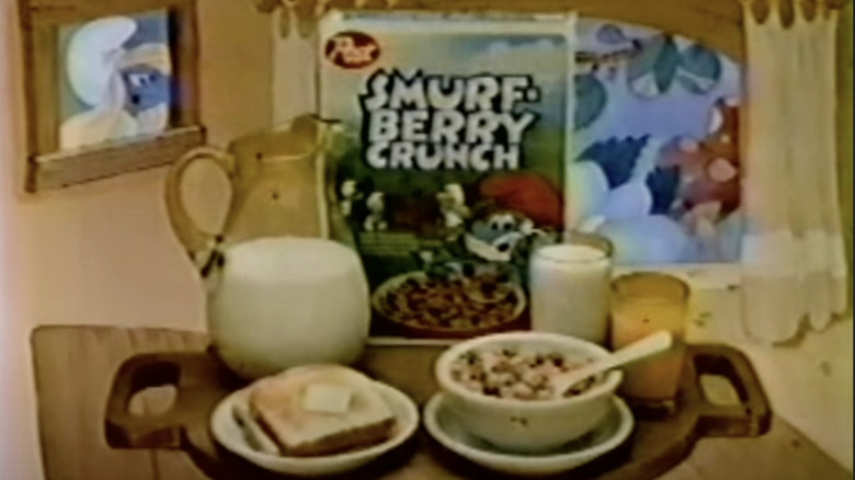 Breakfast spread featuring Smurf-Berry Crunch cereal set on table