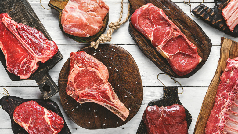 Various cuts of meat displayed on wooden serving platters
