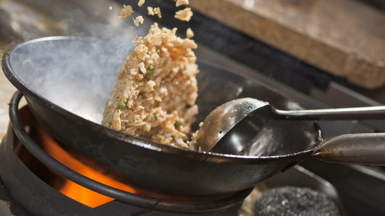cooking fried rice in wok
