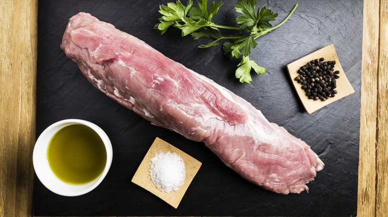 Pork tenderloin with seasoning and oil