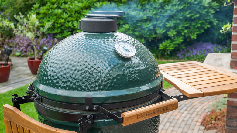 Big Green Egg with smoke coming out the chimney