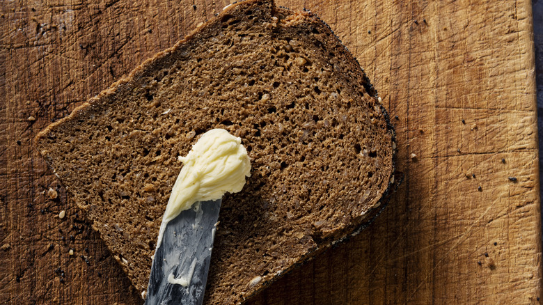 Buttered knife on rye bread