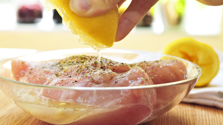 Person marinating chicken