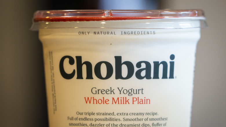 A container of Greek yogurt is made with whole milk.