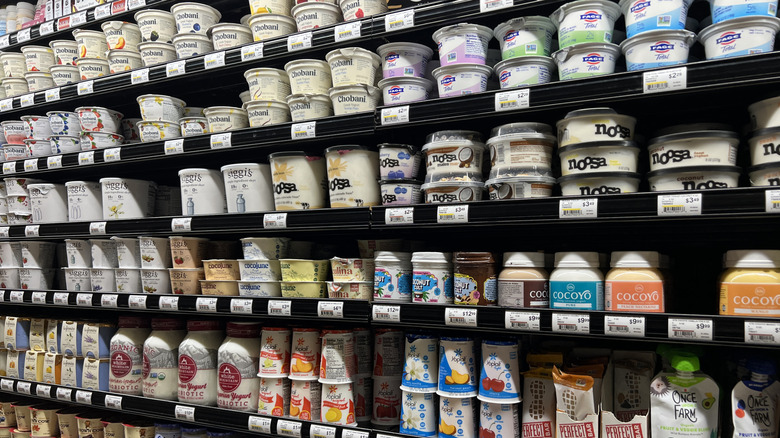 A grocery store dairy aisle is filled with yogurt.