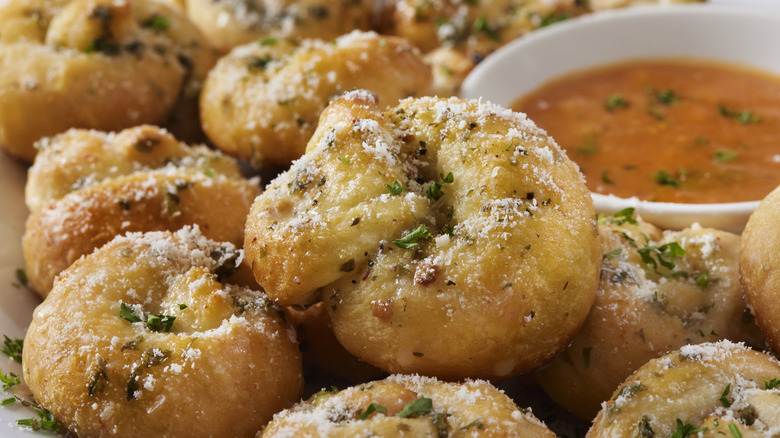 Garlic knots with tomato sauce and Parmesan cheese