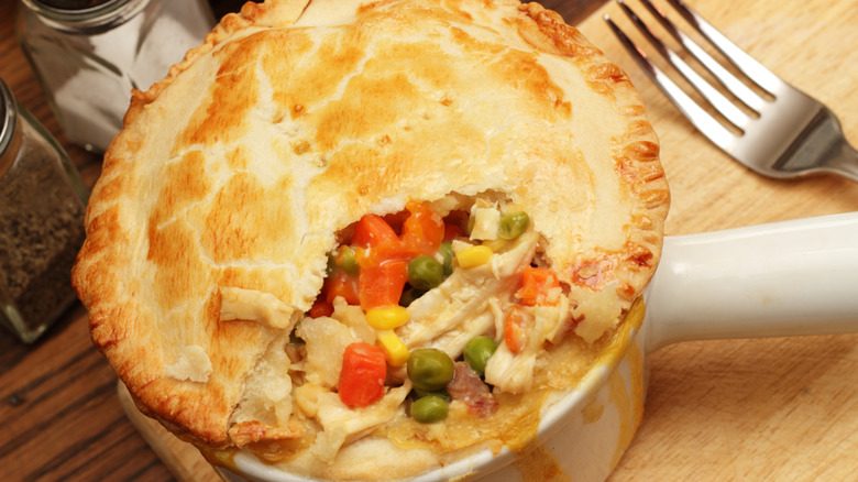 Top of a chicken pot pie with vegetables and fork