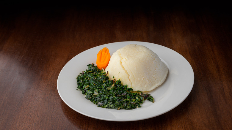 Plate of ugali with cooked vegetables