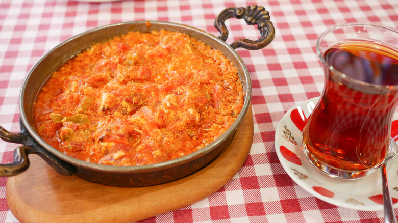 Dish of menemen with a glass of tea