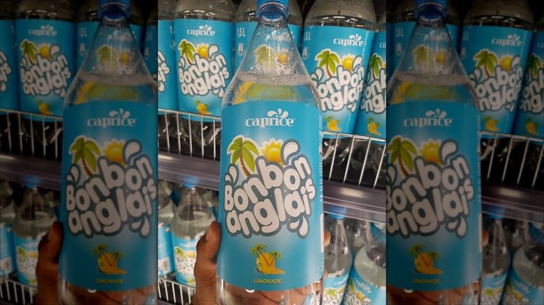 person holding Bonbon Anglais bottle