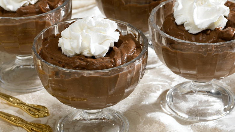 glass cup of chocolate pudding topped with whipped cream