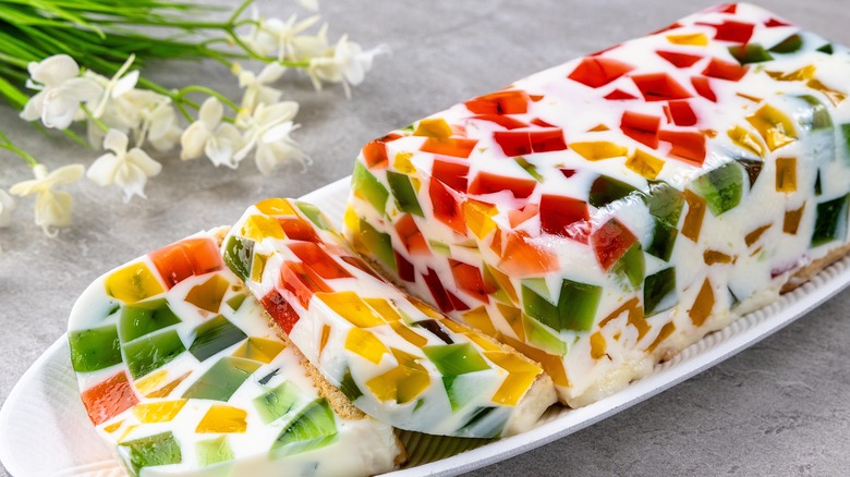 broken glass cake sliced and displayed on a white platter