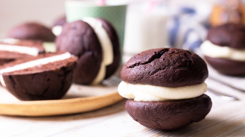 whoopie pie sitting on a counter with other whoopie pies behind him