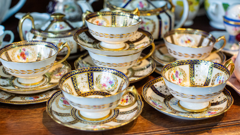 teacups and saucers arranged on tabletop