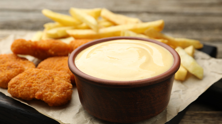 Chicken nuggets and dipping sauce with french fries
